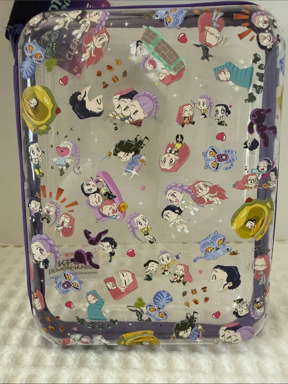 Netflix K-POP Demon Hunters Chibi-Style Clear PVC Pencil Case with Purple Trim.
